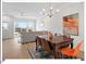 Bright dining area features hardwood floors, stylish chandelier, and an open-concept design to the living room at 712 E Edenton St # 105, Raleigh, NC 27601