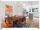 Bright dining area features hardwood floors, stylish chandelier, and an open-concept design to the kitchen at 712 E Edenton St # 105, Raleigh, NC 27601