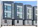 Modern three-story townhouses with gray siding and large windows at 712 E Edenton St # 105, Raleigh, NC 27601