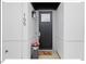 Contemporary black front door with a welcome mat and potted plants at 712 E Edenton St # 105, Raleigh, NC 27601