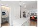 Open-concept kitchen showcasing a sleek island with a quartz countertop, modern lighting, and access to the living room at 712 E Edenton St # 105, Raleigh, NC 27601