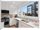 Bright kitchen features stainless steel appliances, white cabinetry, white countertops, and a modern backsplash at 712 E Edenton St # 105, Raleigh, NC 27601