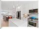 Modern kitchen features stainless steel appliances, white cabinets, and a center island with a white countertop at 712 E Edenton St # 105, Raleigh, NC 27601