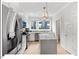 Modern kitchen features stainless steel appliances, white cabinetry, and a kitchen island with bar seating at 712 E Edenton St # 105, Raleigh, NC 27601