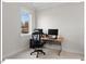 Home office space features a modern desk, ergonomic chair, and window providing natural light at 712 E Edenton St # 105, Raleigh, NC 27601