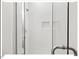 Modern all-white tiled shower featuring sleek glass doors and a shower niche at 712 E Edenton St # 105, Raleigh, NC 27601