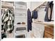 Organized walk-in closet featuring shelving, hanging rods, and storage bins for efficient storage solutions at 712 E Edenton St # 105, Raleigh, NC 27601