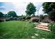 Landscaped backyard with stone steps and lush lawn at 7845 Hasentree Lake Dr, Wake Forest, NC 27587