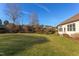 Backyard view showing home, lawn and landscaping at 7845 Hasentree Lake Dr, Wake Forest, NC 27587