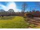 Landscaped backyard with grassy area and stone steps at 7845 Hasentree Lake Dr, Wake Forest, NC 27587