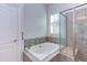 Bathroom with a large soaking tub and glass shower at 7845 Hasentree Lake Dr, Wake Forest, NC 27587