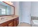 Double vanity bathroom with a large mirror at 7845 Hasentree Lake Dr, Wake Forest, NC 27587