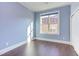 Bright bedroom featuring hardwood floors and large window at 7845 Hasentree Lake Dr, Wake Forest, NC 27587