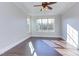 Sunlit bedroom with hardwood floors and large window at 7845 Hasentree Lake Dr, Wake Forest, NC 27587