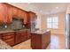 Spacious kitchen with dark wood cabinets, granite countertops, and stainless steel appliances at 7845 Hasentree Lake Dr, Wake Forest, NC 27587