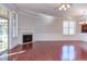 Living room with hardwood floors, fireplace and sunroom access at 7845 Hasentree Lake Dr, Wake Forest, NC 27587