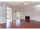 Living room with hardwood floors, fireplace and access to sunroom at 7845 Hasentree Lake Dr, Wake Forest, NC 27587