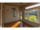 Sunroom with hardwood floors, multiple windows, and backyard view at 7845 Hasentree Lake Dr, Wake Forest, NC 27587