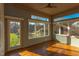 Bright sunroom featuring hardwood floors and backyard access at 7845 Hasentree Lake Dr, Wake Forest, NC 27587