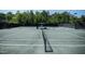 Well-kept community tennis court surrounded by lush greenery and tall black fencing at 7845 Hasentree Lake Dr, Wake Forest, NC 27587