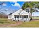 Charming white house with a porch, surrounded by a well-maintained lawn at 8179 Highway 39, Middlesex, NC 27557