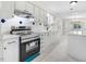 Modern kitchen with stainless steel range and white cabinets at 8179 Highway 39, Middlesex, NC 27557