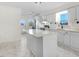 White kitchen with stainless steel appliances and an island at 8179 Highway 39, Middlesex, NC 27557
