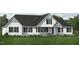 Two-story farmhouse with white siding, black roof, and landscaping at Lot 20H Good Shepherd Ln, Spring Hope, NC 27882