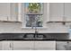 Modern kitchen sink with sleek black countertop and stainless steel faucet at 101 Pebble Springs Rd, Chapel Hill, NC 27514