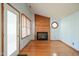 Living room with hardwood floors, brick fireplace, and wood accent wall at 112 Talon Dr, Cary, NC 27518