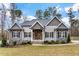 Gray-toned two-story house with stone accents and a double front door at 1134 Bowling Mountain Dr, Stem, NC 27581