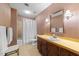 Bright bathroom with a shower and tub combination and vintage wallpaper at 11509 Hardwick Ct, Raleigh, NC 27614