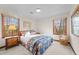 Light bedroom with multiple windows and cozy chair near bed at 11509 Hardwick Ct, Raleigh, NC 27614