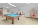 Spacious game room with pool table, swinging chair and natural light at 11509 Hardwick Ct, Raleigh, NC 27614