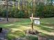 Coachman's Trail community sign highlighting clubhouse and pool amenities amidst natural surroundings at 11509 Hardwick Ct, Raleigh, NC 27614