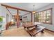 Charming dining area with a rustic table and bench, leading into a cozy living room with a brick fireplace at 11509 Hardwick Ct, Raleigh, NC 27614
