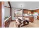 Dining area with a rustic wooden table and bench, complemented by natural light through a large window at 11509 Hardwick Ct, Raleigh, NC 27614