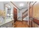 Inviting foyer with hardwood floors, staircase, mirror, and wooden doors at 11509 Hardwick Ct, Raleigh, NC 27614