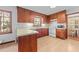 Functional kitchen features wood cabinetry, tile flooring, and efficient appliances at 11509 Hardwick Ct, Raleigh, NC 27614