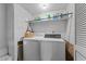 Functional laundry room with a washer and dryer, and shelving for storage at 11509 Hardwick Ct, Raleigh, NC 27614