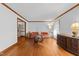 Bright and airy living room features hardwood floors, large windows, and traditional furnishings at 11509 Hardwick Ct, Raleigh, NC 27614