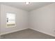 Simple bedroom with neutral walls, carpet, and a window at 124 Northwood Dr, Fuquay Varina, NC 27526