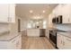 Modern kitchen with white cabinets, granite countertops, and stainless steel appliances at 124 Northwood Dr, Fuquay Varina, NC 27526