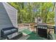 Outdoor wooden deck with furniture and grill with a view of the backyard at 1304 Rothes Rd, Cary, NC 27511