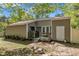 View of the backyard with patio, grill and paver path to lawn and trees at 1304 Rothes Rd, Cary, NC 27511