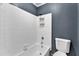 Clean bathroom with a tiled shower-tub, white toilet, and freshly painted walls at 1304 Rothes Rd, Cary, NC 27511