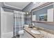 Updated bathroom with granite countertops and a shower-tub combination at 1304 Rothes Rd, Cary, NC 27511