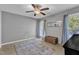 Bright bedroom with a ceiling fan, neutral walls, and a decorative rug at 1304 Rothes Rd, Cary, NC 27511