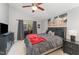 Bright bedroom features gray bedding, a ceiling fan, and coastal artwork at 1304 Rothes Rd, Cary, NC 27511