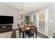 Dining area with chandelier, wooden table, and access to patio at 1304 Rothes Rd, Cary, NC 27511